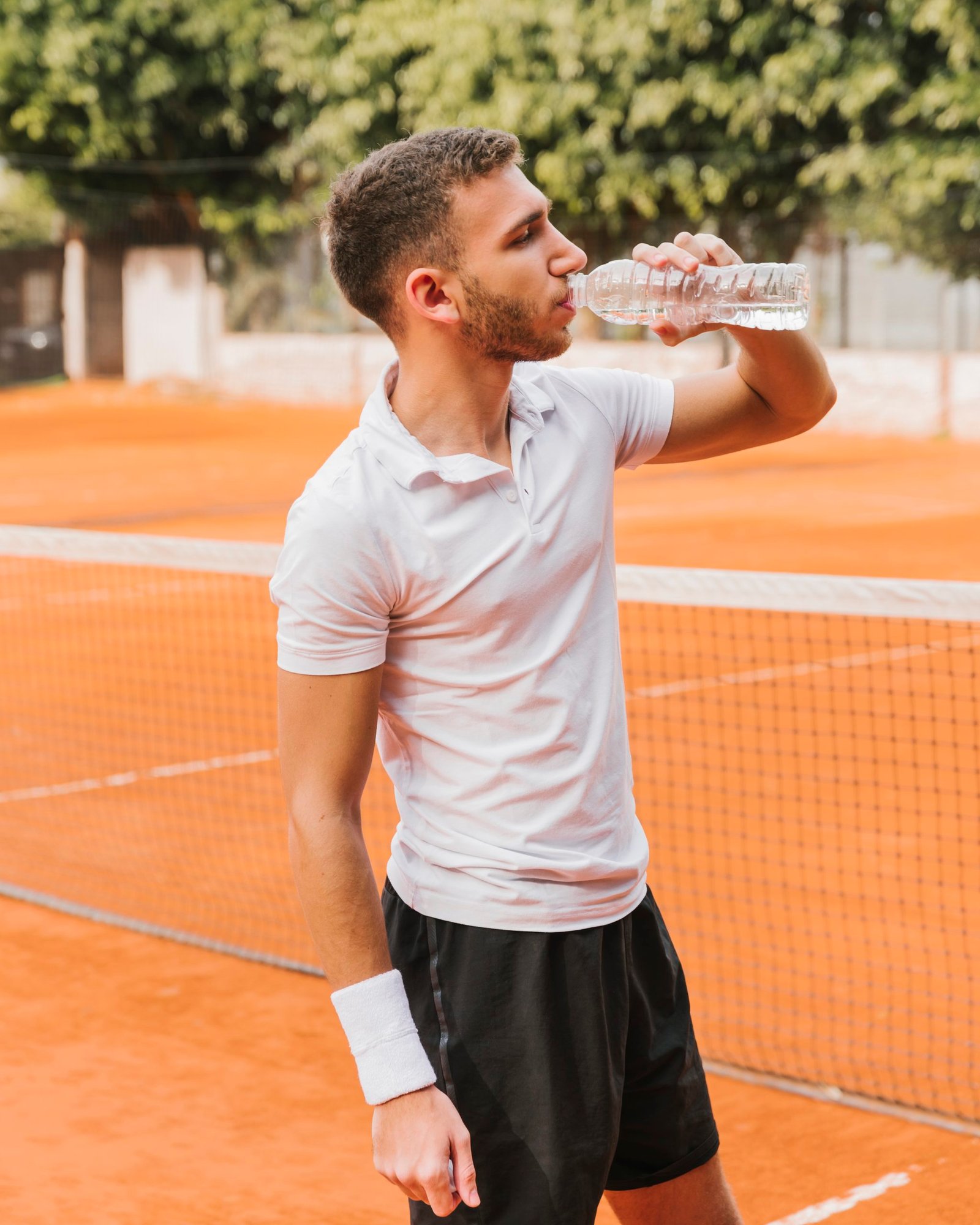 tennis player drinking some water